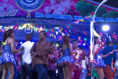 Crowd in illuminated city at night