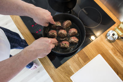 High angle view of man preparing food in kitchen
