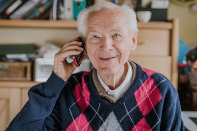 Portrait of smiling senior man talking on phone