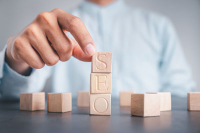 Midsection of man with stuffed toy on table
