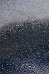 Full frame shot of raindrops on beach