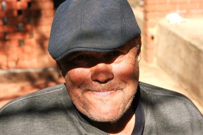 Close-up portrait of smiling man wearing hat