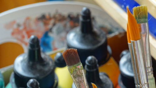 High angle view of paintbrushes with watercolor paints