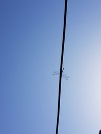 Low angle view of barbed wire against clear sky