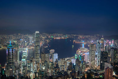 Illuminated cityscape against sky at night