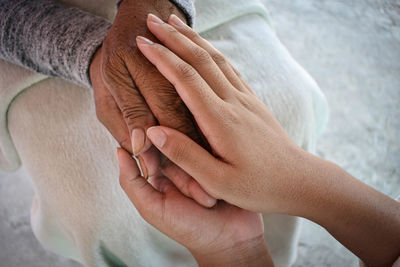 Midsection of woman holding hands