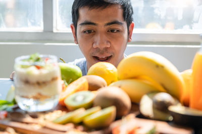 Portrait of smiling man with fruits