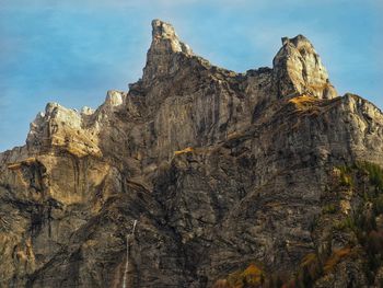 Low angle view of rock formations against sky