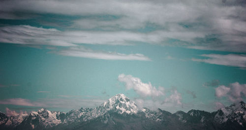 Aerial view of snowcapped mountains against sky