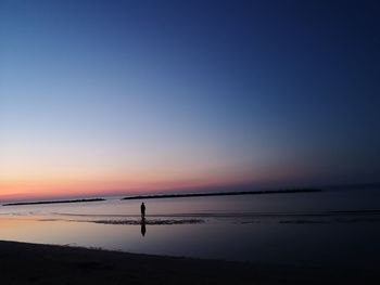 Scenic view of sea against clear sky during sunset