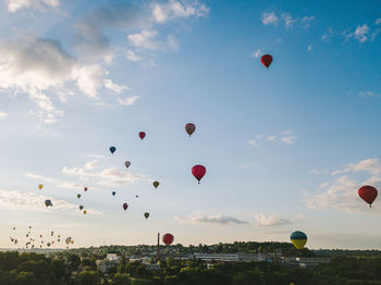 Low angle view of hot air balloons flying in sky