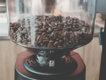 Close-up of coffee beans in glass jar on table