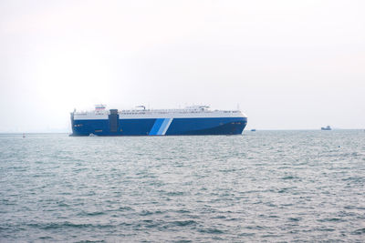 Ship sailing on sea against clear sky