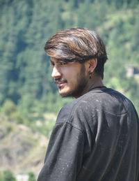 Portrait of young man looking away