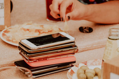 Close-up of mobile phones with woman hands in background