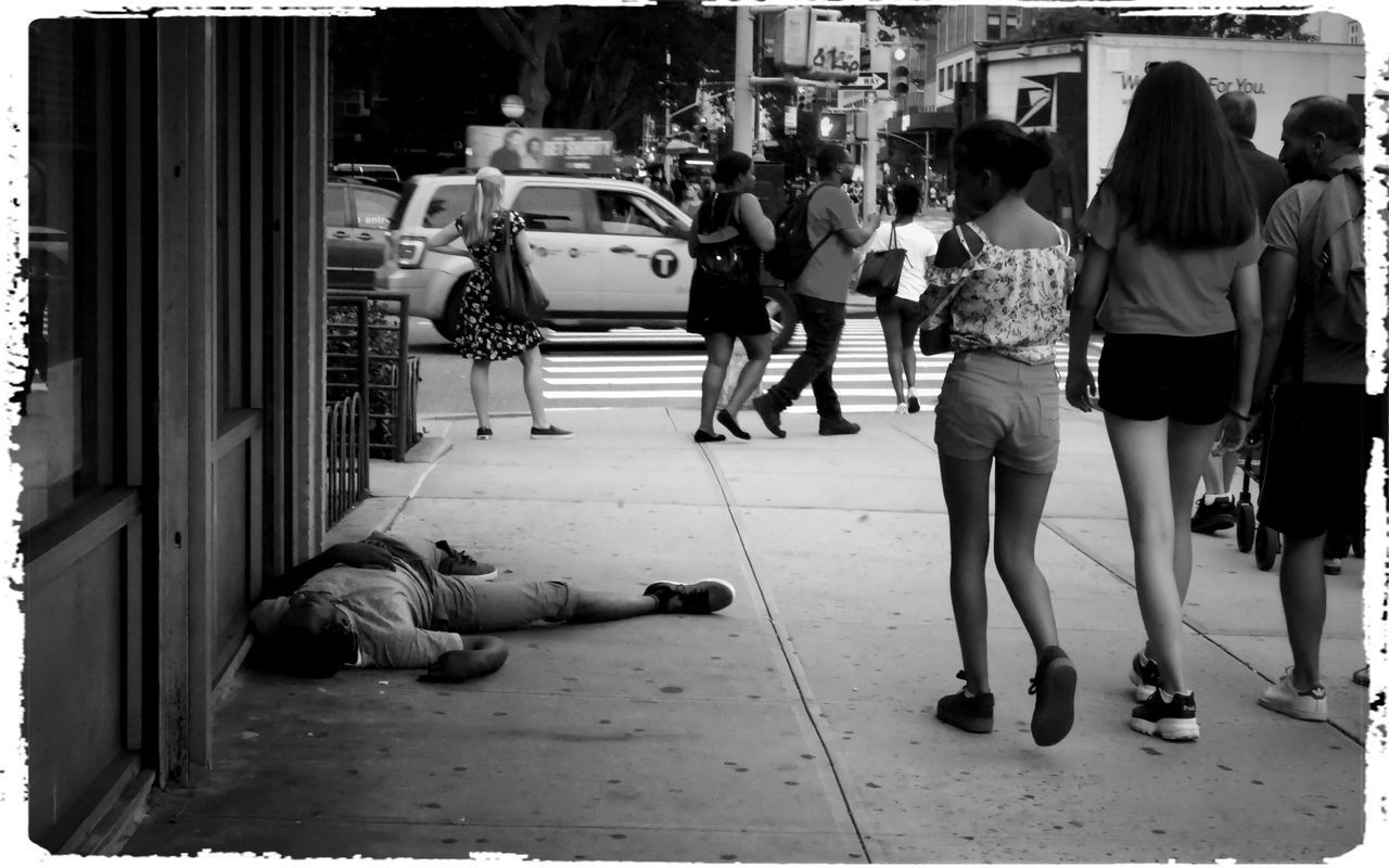 REAR VIEW OF PEOPLE WALKING ON STREET