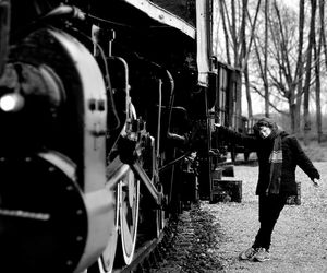 Boy standing by train