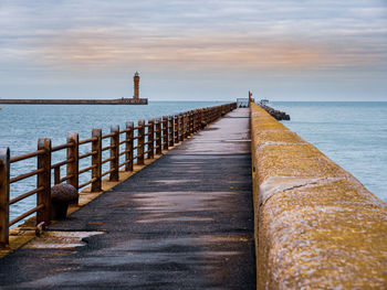 View from the pier towards lighthouse guarding harbour entrance