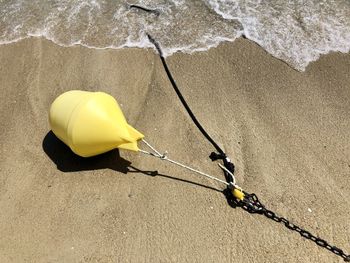 High angle view of yellow umbrella on beach