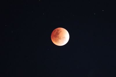 Low angle view of moon against clear sky at night