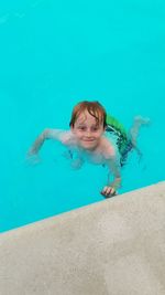 Portrait of smiling boy swimming in pool