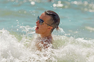 Boy swimming in sea