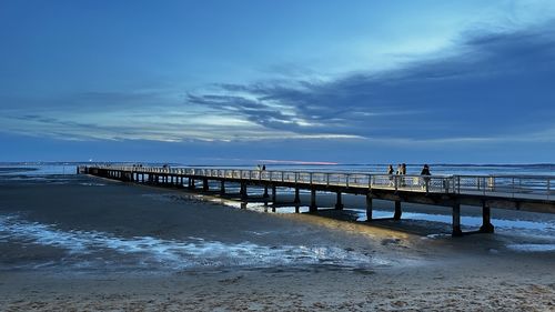 Pier over sea against sky