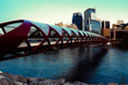 Bridge over river in city against sky