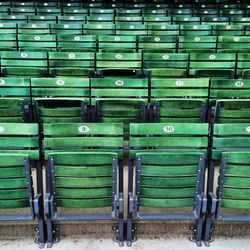 Empty green chairs in stadium