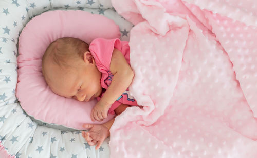 Cute baby sleeping on bed at home