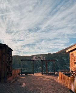 Text on wall against sky