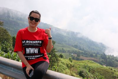 Portrait of young female sitting on mountain