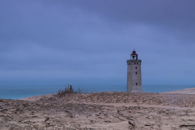 Lighthouse rubjerg knude at sunset on a stormy evening with dramatic sky