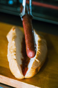 Close-up of hotdog in making.