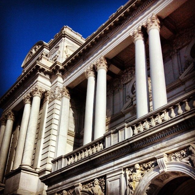 architecture, built structure, low angle view, building exterior, architectural column, famous place, history, travel destinations, column, tourism, travel, international landmark, capital cities, clear sky, blue, statue, facade, culture, sculpture, ornate