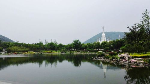 Calm lake against clear sky