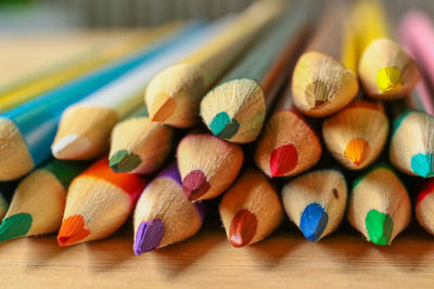 Close-up of multi colored pencils on table