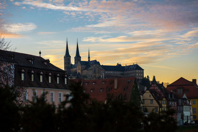 Buildings in city at sunset