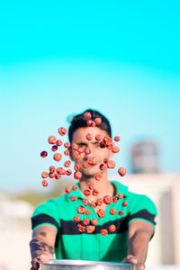 Portrait of mid adult woman standing against blue sky