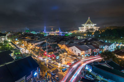 High angle view of city lit up at night