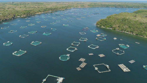 Fish farm with cages for fish and shrimp. aerial view of fish ponds for bangus, milkfish.