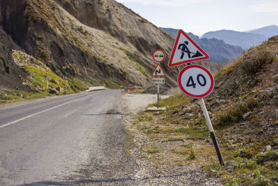 Road sign by mountains