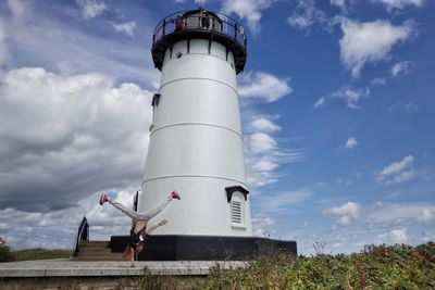 Low angle view of lighthouse against building