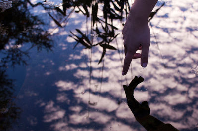 High angle view of  hand reflected in water