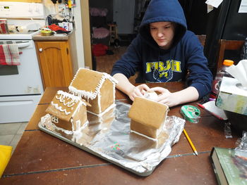 Girls making gingerbread village.
