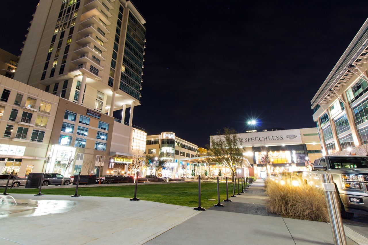 building exterior, night, illuminated, architecture, built structure, city, street light, street, clear sky, building, lighting equipment, city life, sky, residential building, modern, outdoors, cityscape, office building, incidental people, residential structure