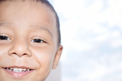 Close-up portrait of smiling boy at home