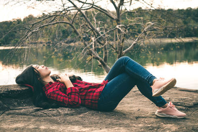 Woman relaxing at lakeshore