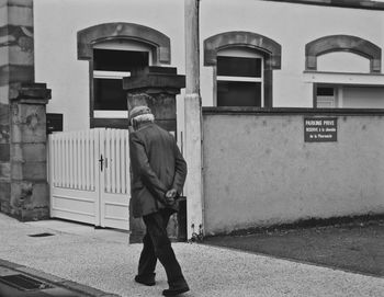 Rear view of man standing in city