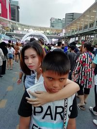 Portrait of people on street in city